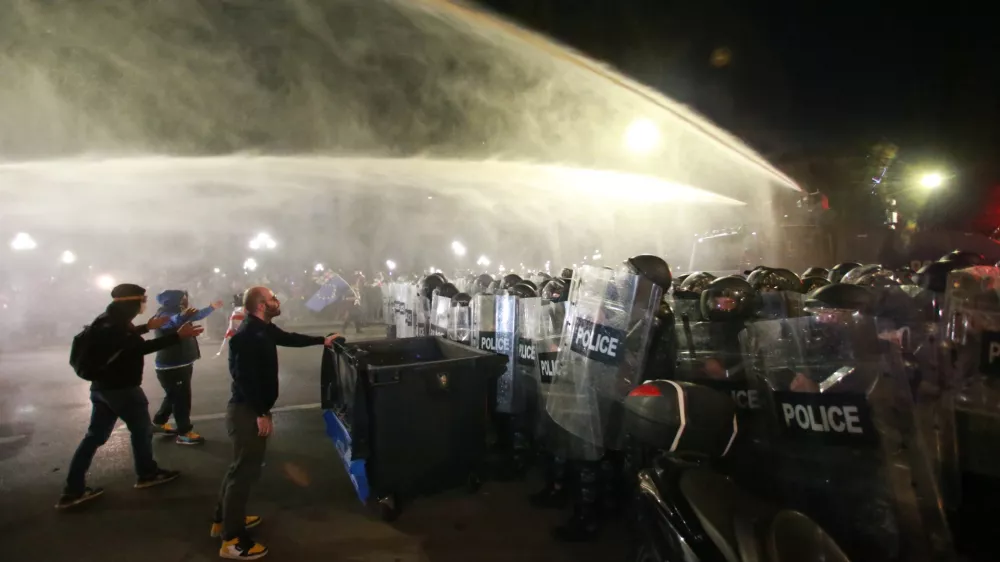 Police use a water cannon to block protesters during an opposition rally in the city center of Tbilisi, Georgia, on Saturday, Oct. 4, 2025, boycotting the municipal elections and call for the release of political opponents. (AP Photo/Zurab Tsertsvadze)