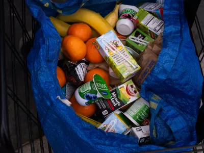 A person stocks their trolley with food from a One Love Community Fridge, Nov. 15, 2025, in Brooklyn, New York. (AP Photo/Adam Gray)