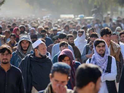 A crowd leaves a stadium after attending the public execution, carried out by Taliban authorities, of a man sentenced by the Supreme Court for killing 13 members of a family, including children, earlier this year, in the eastern city of Khost, eastern Afghanistan, Tuesday, Dec. 2, 2025. (AP Photo/Saifullah Zahir)