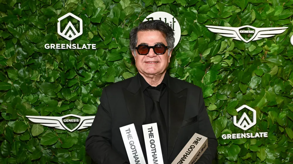 Jafar Panahi poses with the awards for best international feature, best original screenplay and best director at The Gotham Film Awards at Cipriani Wall Street on Monday, Dec. 1, 2025, in New York. (Photo by Evan Agostini/Invision/AP)