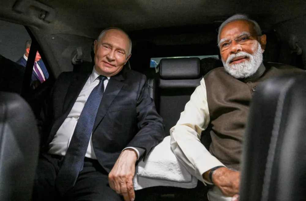 Russian President Vladimir Putin, and Indian Prime Minister Narendra Modi sit inside a limousine after arriving at the Palam Air Base in New Delhi, India, on Thursday, Dec. 4, 2025. (Grigory Sysoyev, Sputnik, Kremlin Pool Photo via AP)
