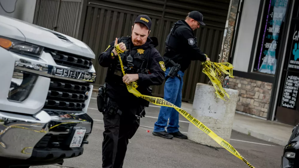 Investigators with the San Joaquin Sheriff's Department remove crime scene tape at Thornton Blvd. and Lucile Ave., where a mass shooting took place Saturday in a banquet hall in Stockton, Calif., Sunday, Nov. 30, 2025. (Bront&euml; Wittpenn/San Francisco Chronicle via AP)