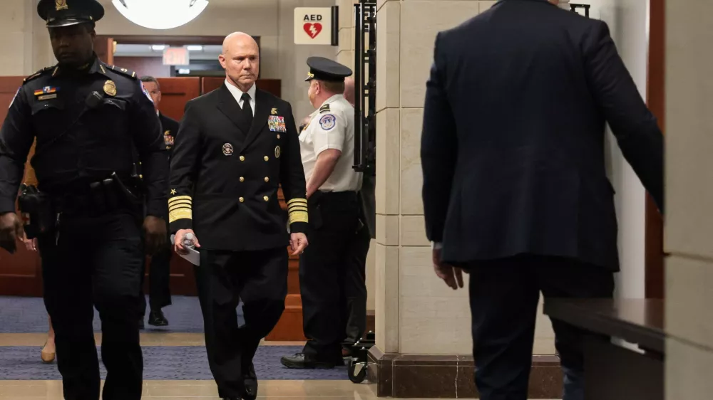 U.S. Navy Admiral Frank "Mitch" Bradley walks in a hallway, as he departs a classified briefing for leaders of the Senate Armed Services Committee on U.S. strikes against Venezuelan boats suspected of smuggling drugs, on Capitol Hill in Washington, D.C., U.S., December 4, 2025. REUTERS/Jonathan Ernst