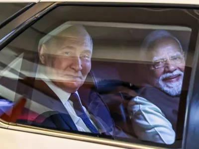 Russian President Vladimir Putin, left, and Indian Prime Minister Narendra Modi sit inside a limousine as they arrive at the Indian Prime Minister office in New Delhi, India, on Thursday, Dec. 4, 2025. (Alexander Kazakov, Sputnik, Kremlin Pool Photo via AP)