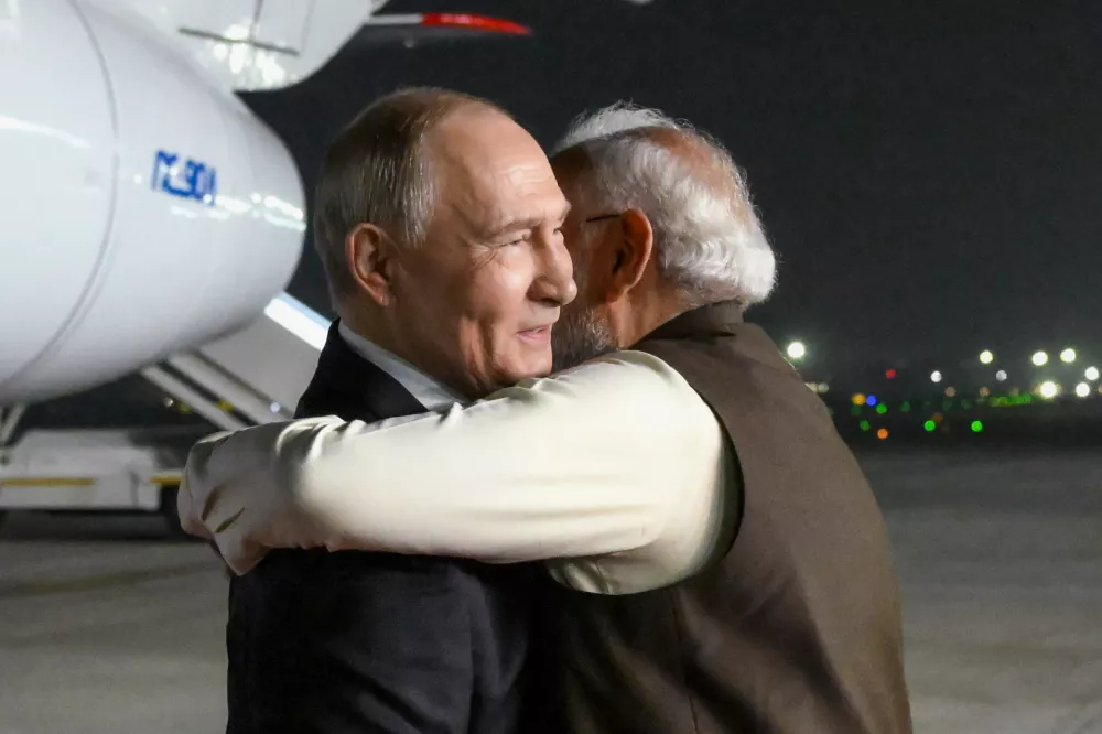 Russian President Vladimir Putin, left, and Indian Prime Minister Narendra Modi embrace each other at the Palam Air Base in New Delhi, India, Thursday, Dec. 4, 2025. (Grigory Sysoyev, Sputnik, Kremlin Pool Photo via AP)