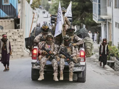 Taliban fighters parade in the streets during the celebrations marking the fourth anniversary of the U.S. withdrawal and the start of Taliban rule in Kabul, Afghanistan, Friday, Aug. 15, 2025. (AP Photo/Siddiqullah Alizai)