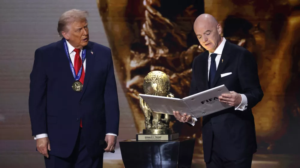 Dec 5, 2025; Washington, District of Columbia, USA; FIFA president Gianni Infantino presents United States President Donald Trump with the FIFA Peace Prize during the FIFA World Cup 2026 Final Draw at John F. Kennedy Center for the Performing Arts. Mandatory Credit: Amber Searls-Imagn Images