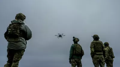A Ukrainian drone operator from the Kraken 1654 unit, callsign Imla, left, flies a Vampire drone as other soldiers watch, during a demonstration for The Associated Press, Wednesday, Nov. 5, 2025, in Kharkiv Oblast, Ukraine. (AP Photo/Julia Demaree Nikhinson)