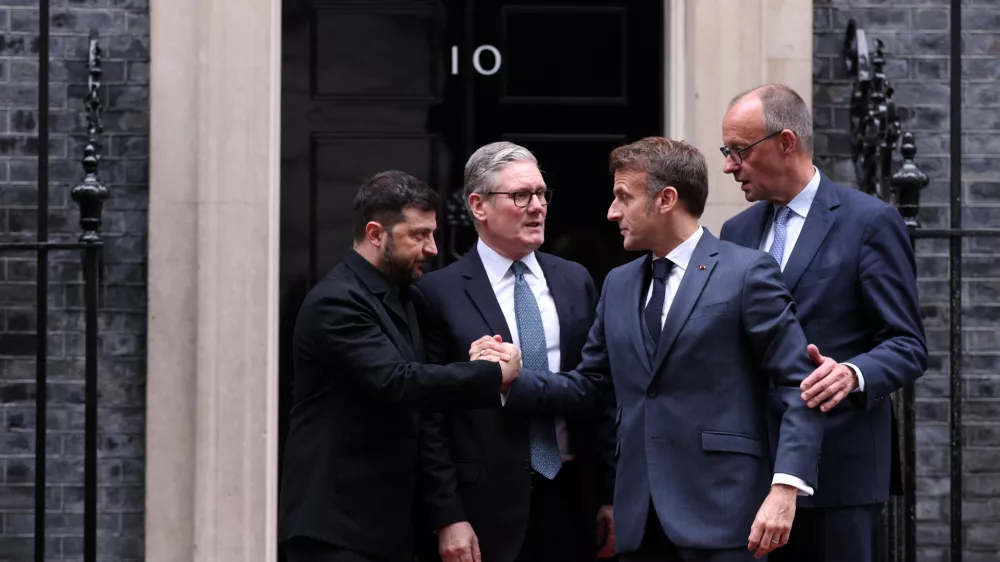 Ukraine's President Volodymyr Zelenskiy and French President Emmanuel Macron shake hands on the 10 Downing Street doorstep after a meeting with Britain's Prime Minister Keir Starmer and Germany's Chancellor Friedrich Merz, in London, Britain, December 8, 2025. ADRIAN DENNIS/Pool via REUTERS