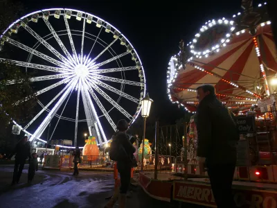 A giant ferris wheel is lit up on the opening night of 'Winter Wonderland', a christmas market and fun fair that is open to the public, in Hyde Park in London, Thursday, Nov. 17, 2011. (AP Photo/Kirsty Wigglesworth)