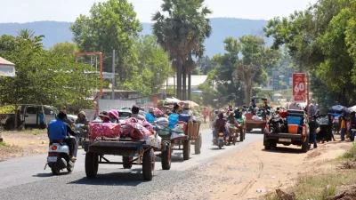 People flee amid clashes between Thailand and Cambodia along a disputed border area, in Oddar Meanchey Province, Cambodia, December 8, 2025. Agence Kampuchea Press/Handout via REUTERS  THIS IMAGE HAS BEEN SUPPLIED BY A THIRD PARTY. NO RESALES. NO ARCHIVES.