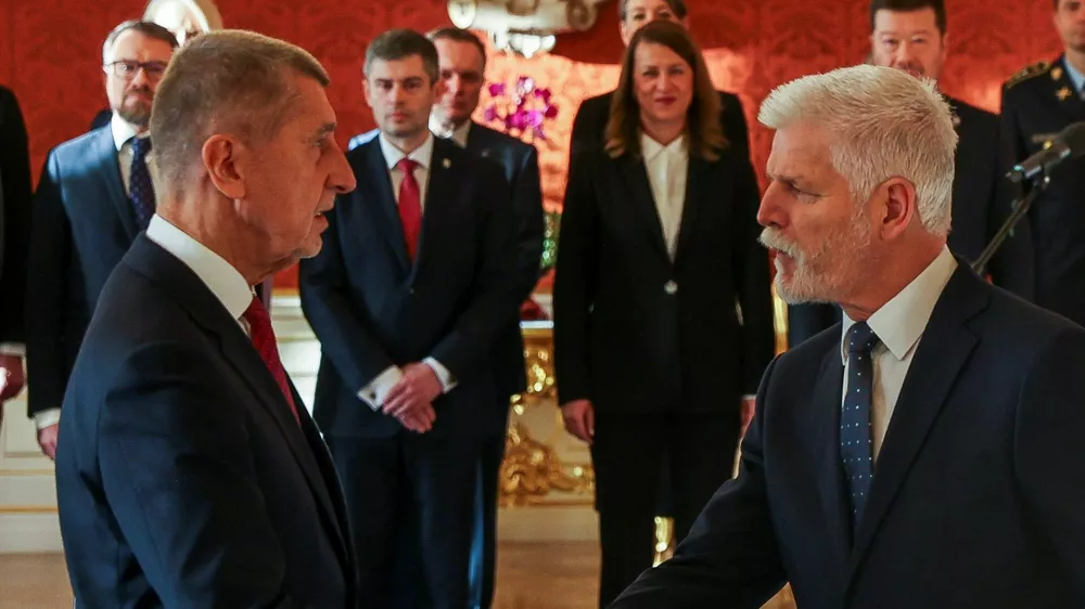 Czech President Petr Pavel shakes hands with the ANO party leader Andrej Babis on the day of appointing him as the country's new Prime Minister at Prague Castle in Prague, Czech Republic December 9, 2025. REUTERS/Eva Korinkova