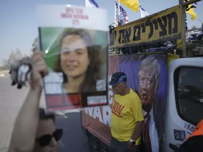 People take part in a protest demanding an end to the war and the immediate release of hostages held by Hamas in the Gaza Strip, at the site of the October 7, 2023 Hamas attack on the Nova music festival near Kibbutz Reim, southern Israel, Wednesday, July 2, 2025. (AP Photo/Ohad Zwigenberg)