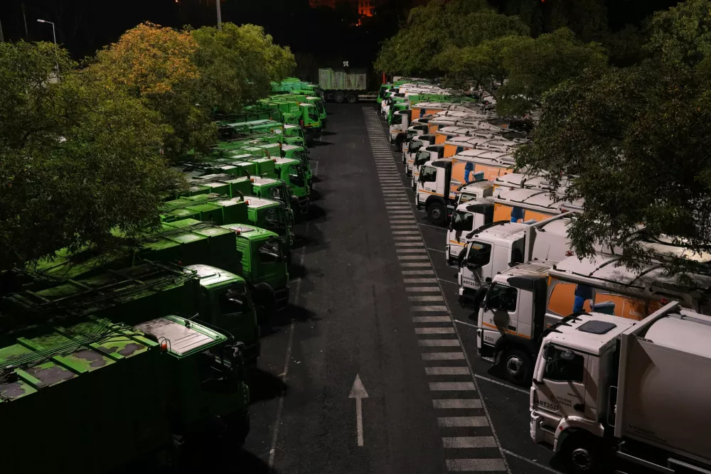 Trucks sit idle at a garbage processing center in Lisbon at the start of a general strike on Wednesday night, Dec. 10, 2025, held to protest a new labor package announced by Portugal's center-right government. (AP Photo/Ana Brigida)