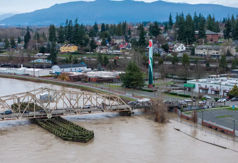 Water from the Skagit River reaches a flood wall on Thursday, Dec. 11, 2025, in Mount Vernon, Wash. (AP Photo/Stephen Brashear)