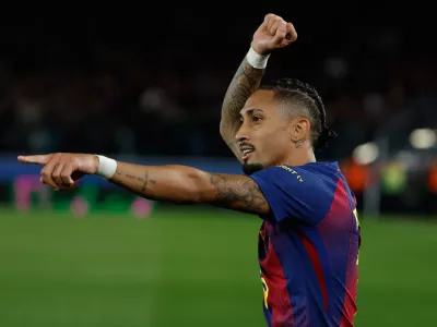 Barcelona's Raphinha celebrates after scoring during a La Liga soccer match between Barcelona and Osasuna in Barcelona, Spain, Saturday, Dec. 13, 2025. AP Photo/Joan Monfort)