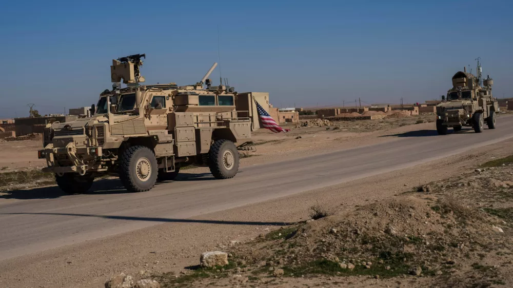 FILE - A U.S. military convoy drives along a road in northeastern Syria's Hasakeh province, Thursday, Jan. 30, 2025. (AP Photo/Bernat Armangue, File)
