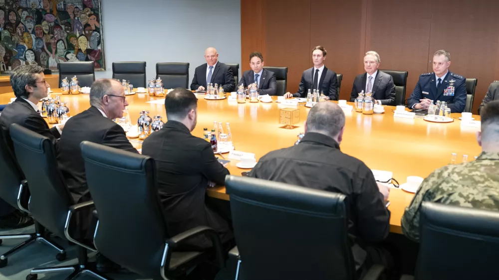 HANDOUT - 14 December 2025, Berlin: (L-R) Guenter Sautter, foreign and security policy adviser to German Chancellor Friedrich Merz, Chancellor Merz, Ukrainian President Volodymyr Zelensky, and former defence minister Rustem Umjerow sit opposite the US delegation at the start of their meeting at the Federal Chancellery, including Jared Kushner (centre, back row) and US special envoy Steve Witkoff (second right, back row). US representatives are in Berlin to discuss a possible ceasefire with Ukrainian and European officials. Photo: Guido Bergmann/Presse- und Informationsamt der Bundesregierung - ATTENTION: editorial use only and only if the credit mentioned above is referenced in full