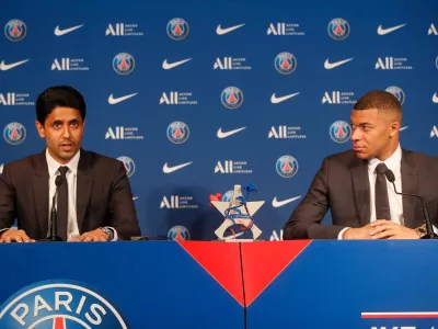 FILE - PSG striker Kylian Mbappe, right, and PSG president Nasser Al-Al-Khelaifi attend a press conference Monday, May 23, 2022 at the Paris des Princes stadium in Paris. (AP Photo/Michel Spingler, File)
