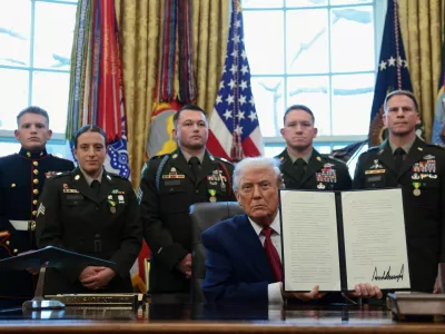 U.S. President Donald Trump shows a signed executive order classifying fentanyl as 'weapon of mass destruction' during a Mexican Border Defense Medal presentation in the Oval Office at the White House in Washington, D.C., U.S., December 15, 2025. REUTERS/Evelyn Hockstein