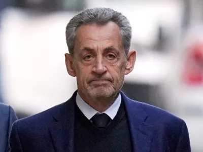 FILE - Former French President Nicolas Sarkozy leaves his home Tuesday, Oct. 21, 2025 in Paris as he heads to prison to serve time for a criminal conspiracy to finance his 2007 election campaign with funds from Libya. (AP Photo/Thibault Camus, File)