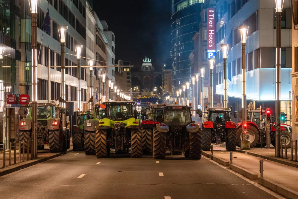 Farmers drive their tractors to block a main boulevard during a demonstration outside a gathering of European leaders at the EU Summit in Brussels, Thursday, Dec. 18, 2025. (AP Photo/Marius Burgelman)