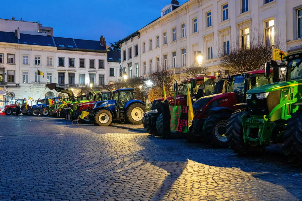 Tractors from European farmers are parked in a main square during a demonstration outside a gathering of European leaders at the EU Summit in Brussels, Thursday, Dec. 18, 2025. (AP Photo/Marius Burgelman)