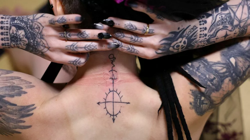 A 33-year-old Australian woman who says she is in a romantic relationship with Japanese manga character Mephisto Pheles shows a tattoo symbolizing the character before their ceremonial wedding at the traditional guest house Rinkokaku in Maebashi, Japan, March 14, 2025. REUTERS/Kim Kyung-Hoon  SEARCH "JAPAN KYUNG-HOON AI WEDDING" FOR THIS STORY. SEARCH "WIDER IMAGE" FOR ALL STORIES.