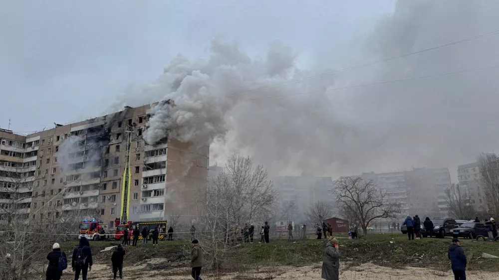 FILE PHOTO: Residents walk in front of an apartment building hit by a Russian air strike, amid Russia's attack on Ukraine, in Zaporizhzhia, Ukraine December 17, 2025. REUTERS/Stringer/File Photo