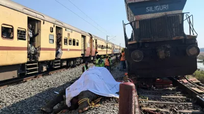 Train passengers use their mobile phones to take photographs of a dead elephant after it was hit by a train in Hojai district in the eastern state of Assam, India, December 20, 2025. REUTERS/Biki Das