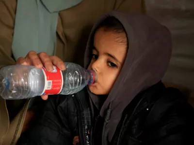 Displaced Palestinian child Yasser Arafat, 5, who, according to medics, suffers from severe acute malnutrition with nutritional edema, drinks water inside their family's tent at a displacement camp in Khan Younis, southern Gaza Strip, December 16, 2025. REUTERS/Haseeb Alwazeer
