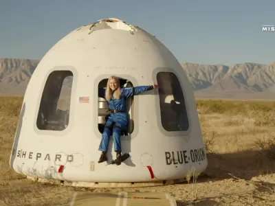 This image provided by Blue Origin, Michaela Benthaus poses after the Blue Origin's capsule landed on Saturday, Dec. 20, 2025 in West Texas. (Blue Origin via AP)