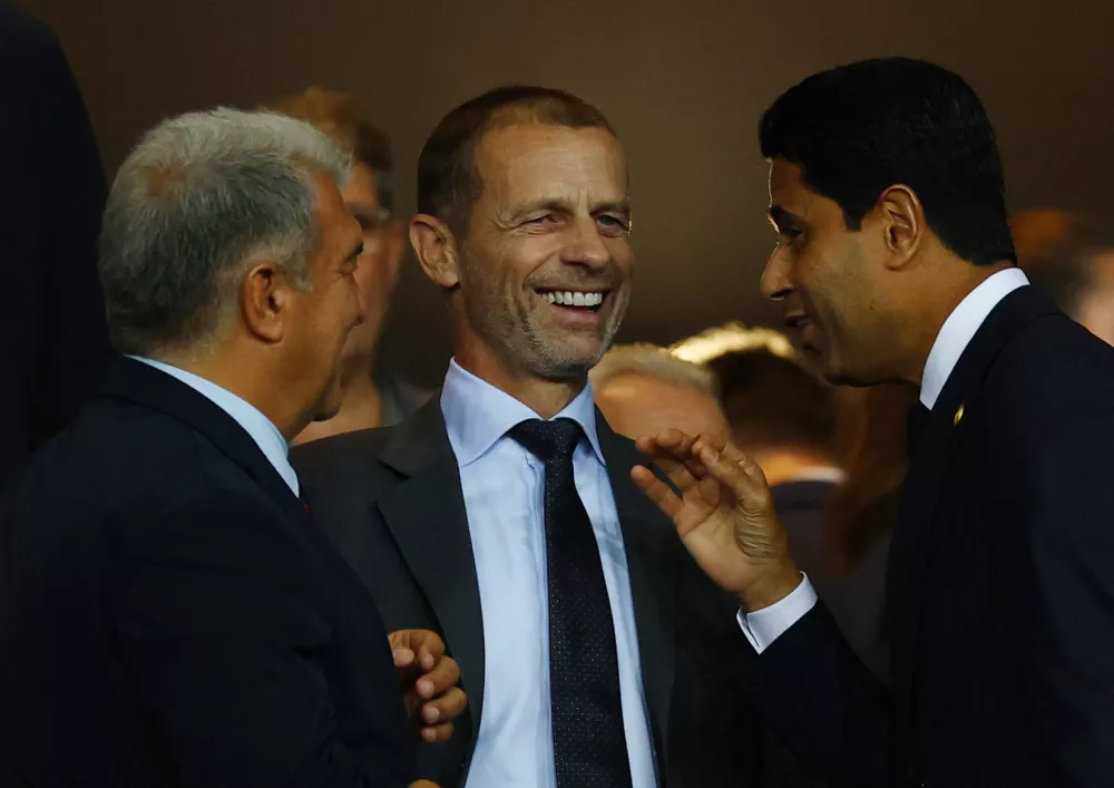Soccer Football - UEFA Champions League - FC Barcelona v Paris St Germain - Estadi Olimpic Lluis Companys, Barcelona, Spain - October 1, 2025 FC Barcelona president Joan Laporta, UEFA president Aleksander Ceferin and Paris St Germain president Nasser Al-Khelaifi talk in the stands before the match REUTERS/Albert Gea