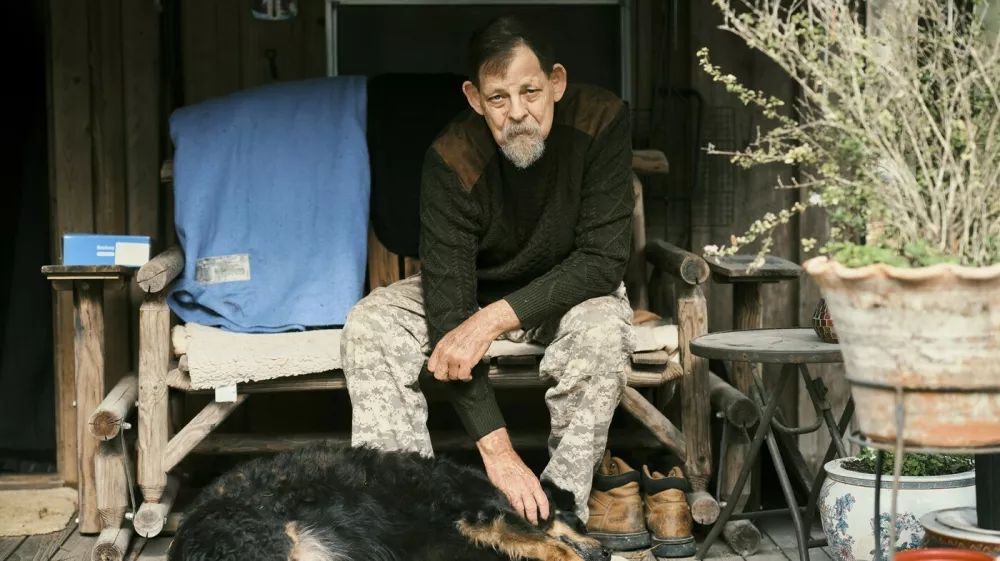 John Koch, a radio reporter in North Florida, at his home with his dog in McAlpin, Fla., on Sunday, Dec. 14, 2025. John Koch, a radio reporter, witnesses every execution in Florida to keep close tabs on what he considers one of the most consequential actions the state takes.,Image: 1060422251, License: Rights-managed, Restrictions:, Model Release: no