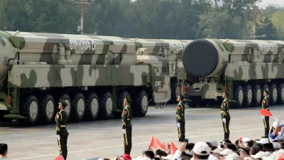 FILE PHOTO: Military vehicles carrying intercontinental ballistic missiles DF-31AG travel past Tiananmen Square during the military parade marking the 70th founding anniversary of People's Republic of China, on its National Day in Beijing, China October 1, 2019./File Photo