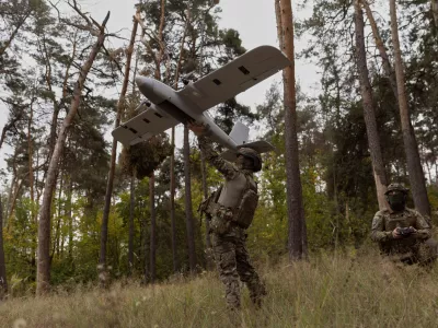 Ukrainian soldiers prepare to launch an Avenger UAV drone in Ukraine's Kharkiv region, Wednesday, Sept. 24, 2025. (AP Photo/Yevhen Titov)
