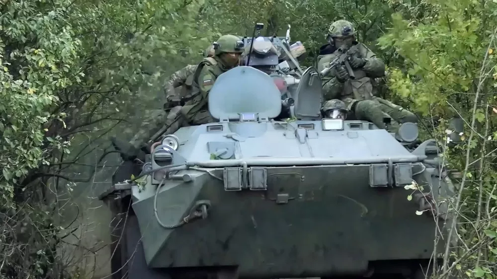 In this photo taken from video released by Russian Defense Ministry Press Service on Monday, Sept. 29, 2025, Russian soldiers ride an APC on an undisclosed location in Ukraine. (Russian Defense Ministry Press Service via AP)