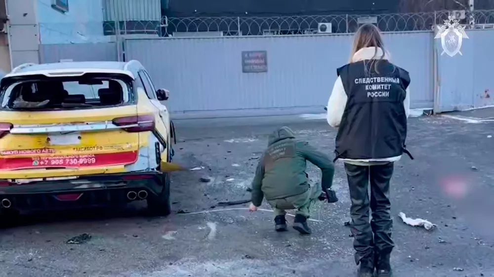 This image taken from video provided by Investigative Committee of Moscow, shows investigators working near the scene of a deadly explosion in Moscow, Wednesday, Dec. 24, 2025. (Investigative Committee of Moscow via AP)
