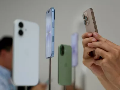 FILE PHOTO: A person uses a phone to capture iPhones on display during Apple's event at the Steve Jobs Theater in Cupertino, California, U.S. September 9, 2025. REUTERS/Manuel Orbegozo/File Photo