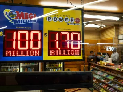 Jackpot payouts for Powerball and Mega Millions are displayed at a convenience store, Tuesday, Dec. 23, 2025, in New York. (AP Photo/Yuki Iwamura)