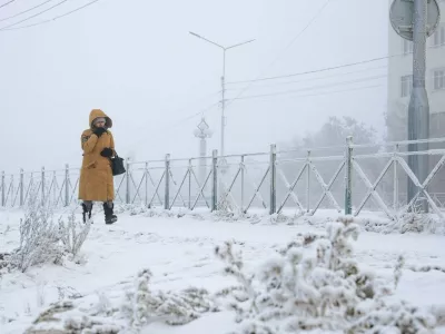 RUSSIA, YAKUTSK - DECEMBER 12, 2025: A woman walk along a snowy street as temperatures plunge to as low as -45C [-43F],Image: 1058697928, License: Rights-managed, Restrictions: * Switzerland And Russia Rights Out *, Model Release: no