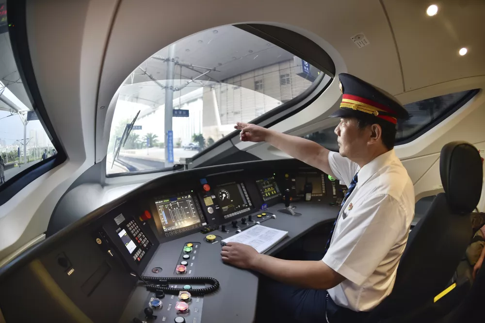 In this Aug. 21, 2017 photo released by China's Xinhua News Agency, a train driver prepares to operate the Fuxing bullet train, China's latest high-speed train, to Beijing from northern China's Tianjin Municipality. China is relaunching the world's fastest bullet trains in September 2017, running at 350 kilometers (217 miles) per hour. China first ran trains at 350 kilometers per hour in August 2008, but cut speeds back to 250-300 kilometers per hour in 2011 following a two-train collision near the city of Wenzhou that killed 40 people and injured 191. (Yang Baosen/Xinhua via AP)
