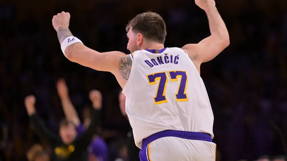 Dec 28, 2025; Los Angeles, California, USA; Los Angeles Lakers guard Luka Doncic (77) reacts after a 3-point basket in the second half against the Sacramento Kings at Crypto.com Arena. Mandatory Credit: Jayne Kamin-Oncea-Imagn Images