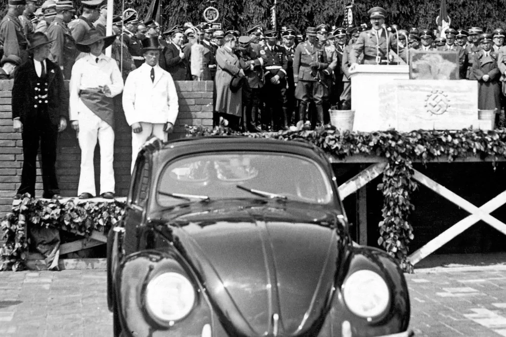 HITLERBIRTHDAY, 1938..Adolf Hitler (onstage) laying a foundation stone at the Volkswagen factory in Fallersleben, Germany, to celebrate his 50th birthday, 1938.