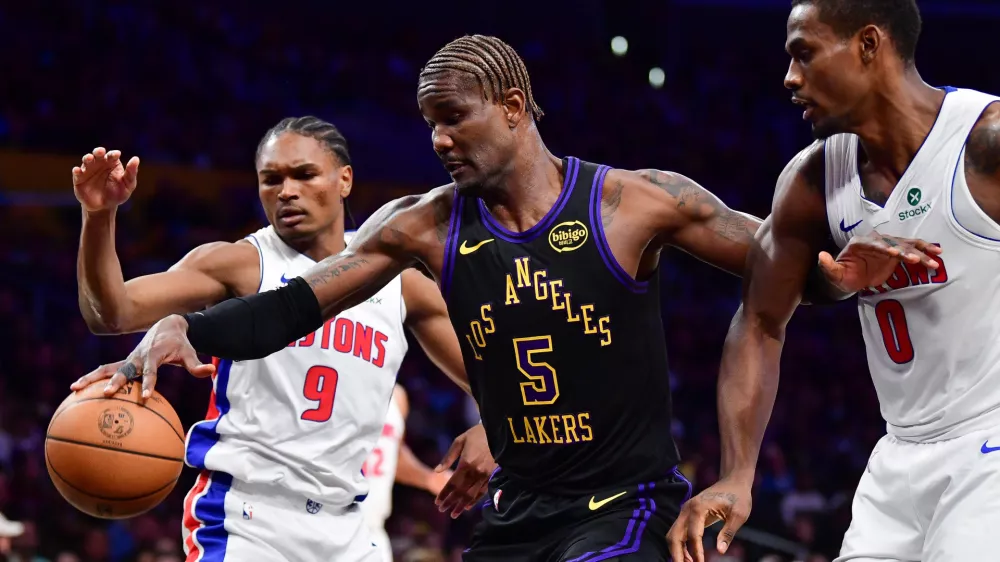 Dec 30, 2025; Los Angeles, California, USA; Los Angeles Lakers center Deandre Ayton (5) plays for the ball against Detroit Pistons guard Ausar Thompson (9) and center Jalen Duren (0) during the first half at Crypto.com Arena. Mandatory Credit: Gary A. Vasquez-Imagn Images