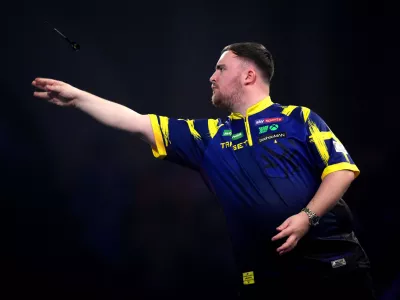 England's Luke Littler in action during his match against England's Rob Cross on day sixteen of the World Darts Championship at the Alexandra Palace, in London, Monday, Dec. 29, 2025. (John Walton/PA via AP)