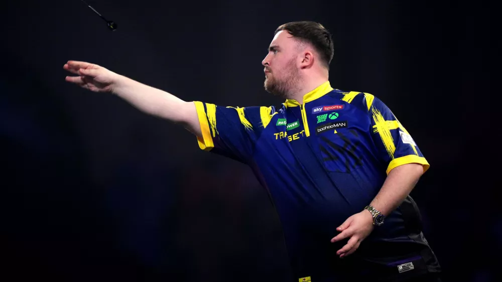 England's Luke Littler in action during his match against England's Rob Cross on day sixteen of the World Darts Championship at the Alexandra Palace, in London, Monday, Dec. 29, 2025. (John Walton/PA via AP)