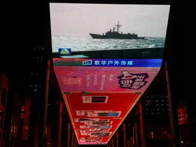 A giant screen shows a news report on China's "Justice Mission 2025" military drills around Taiwan, in Beijing, China December 30, 2025. REUTERS/Tingshu Wang