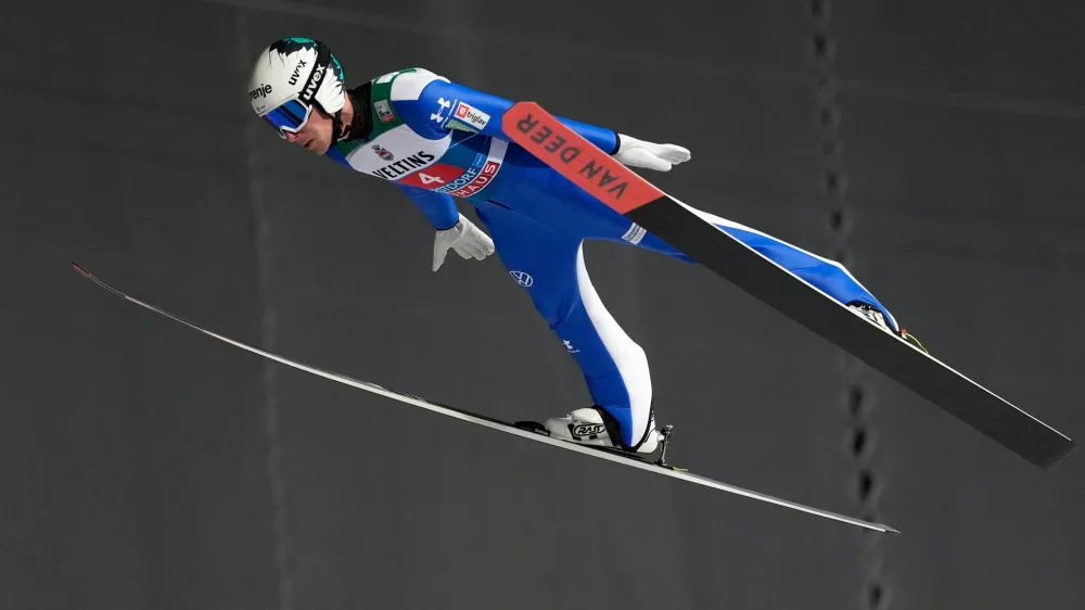 Timi Zajc, of Slovenia, soars through the air during his first round jump at the first stage of the Four Hills ski jumping tournament in Oberstdorf, Germany, Monday, Dec. 29, 2025. (AP Photo/Matthias Schrader)