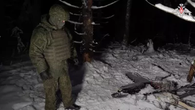 A Russian service member stands next to the remains of a drone, which, according to the Russian Defence Ministry, was downed during the repelling of an alleged Ukrainian attack on the Russian presidential residence in the Novgorod Region, in an unknown location in Russia, in this still image from a video released December 31, 2025. Russian Defence Ministry/Handout via REUTERS ATTENTION EDITORS - THIS IMAGE WAS PROVIDED BY A THIRD PARTY. NO RESALES. NO ARCHIVES. MANDATORY CREDIT. WATERMARK FROM SOURCE.